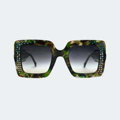 Sunglasses with a green tortoiseshell frame and crystal embellishments