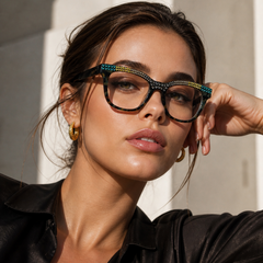 Woman wearing stylish glasses with a Swarovski crystal decorative frame, posing outdoors.
