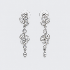 Pair of silver earrings with Austrian crystal stones on a light gray background