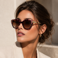 Woman wearing Jimmy Crystal New York GL1871 stylish cateye purple sunglasses embellished with Swarovski crystals