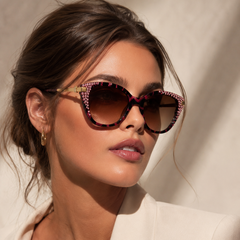 Woman wearing Jimmy Crystal New York GL1871 stylish cateye purple sunglasses embellished with Swarovski crystals