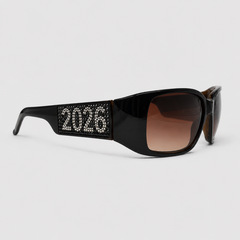 Black sunglasses with '2026' CRYSTAL on the frame against a light gray background